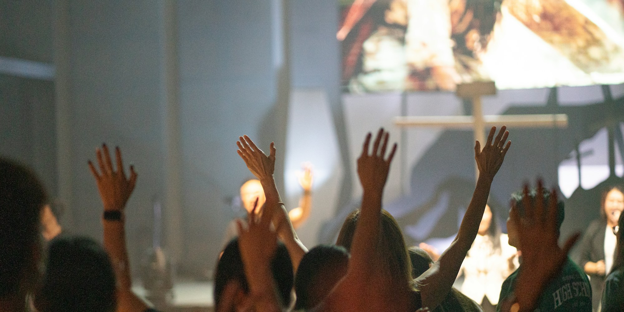 A congregation with hands raised in worship